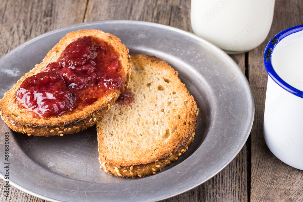 Toasted pieces of bread with strawberry jam.