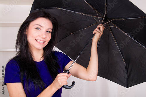 Smiled girl chacking her umbrella before rain photo