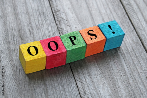 word oops on colorful wooden cubes photo