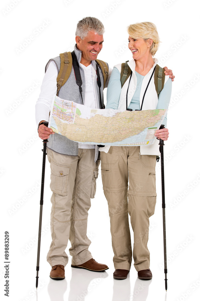 middle aged couple checking directions on a map middle aged couple checking directions on a map