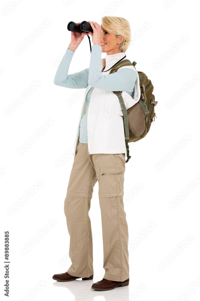 female hiker looking through binoculars female hiker looking through binoculars