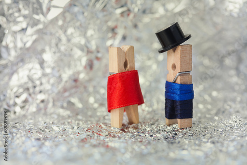 Clothespins: abstract romantic couple. Gentleman in black hat, woman in red dress.
