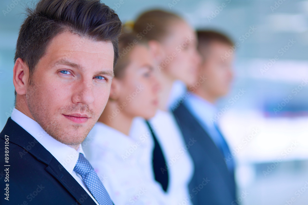 Smiling successful business team standing in office Smiling successful business team standing in office