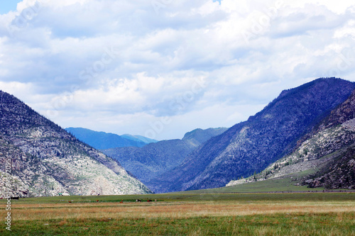 Beautiful Alpine landscape with a highland plane next to the mountains