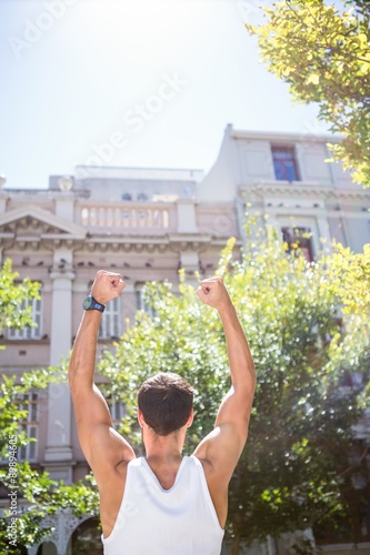 Rear view of an athletic man gesturing victory © WavebreakMediaMicro