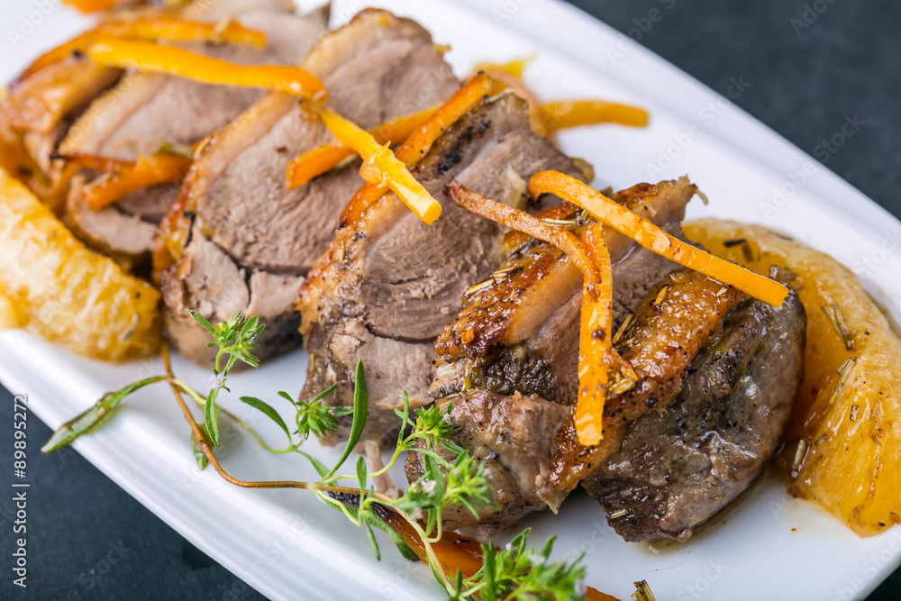 Roasted duck breast in orange on the plate Roasted duck breast in orange on the plate
