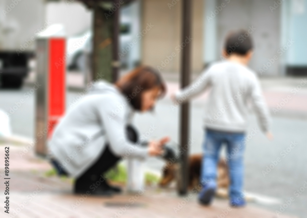 blur of mother and son on sidewalk