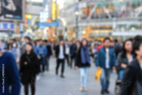 blur of Crowd of anonymous people walking on shibuya street, Tokyo Japan photo
