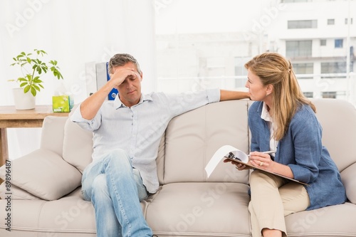 Concerned therapist talking with male patient