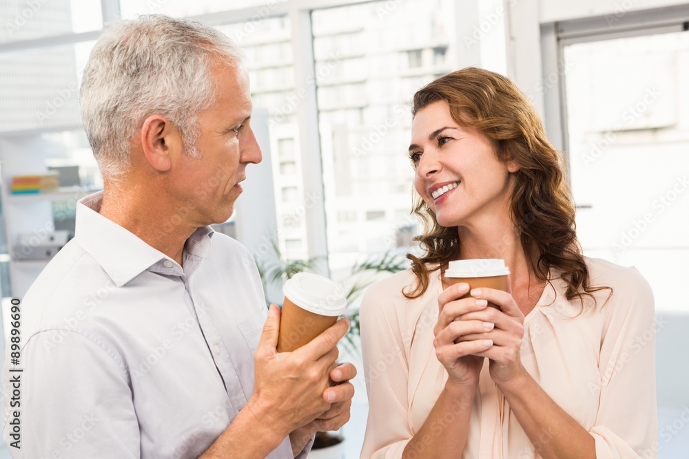 Smiling casual business colleagues having coffee together Smiling casual business colleagues having coffee together