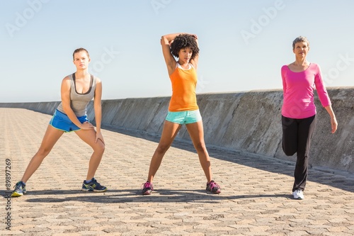 Sporty women stretching together