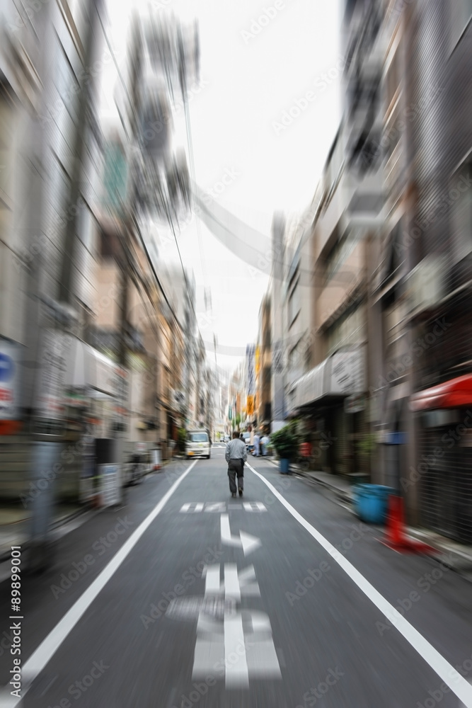 motion blur of man walking on the alley in Tokyo, Japan