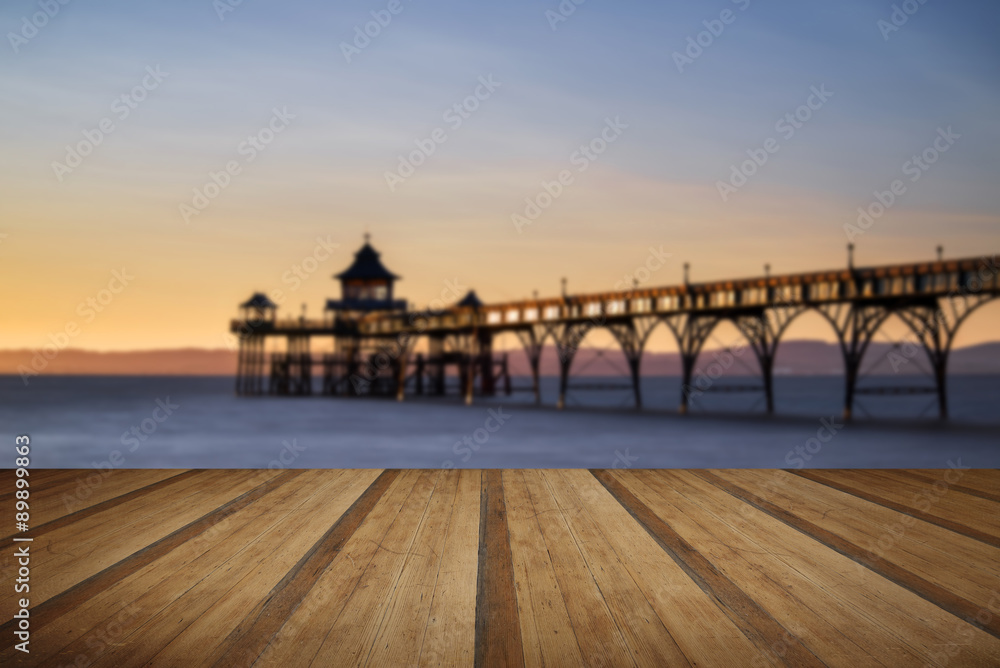 Beautiful long exposure sunset over ocean with pier silhouette w