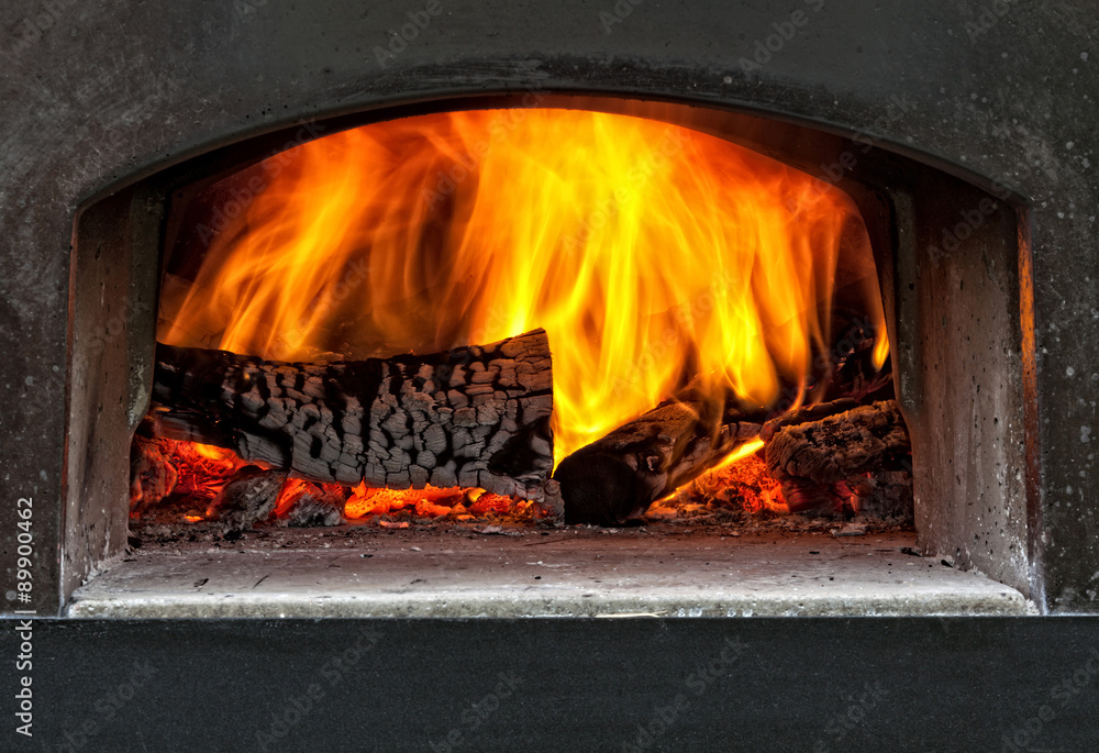 wood burning with flames in a traditional pizza oven. wood burning with flames in a traditional pizza oven.