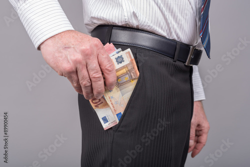 Businessman removing banknotes from his pocket