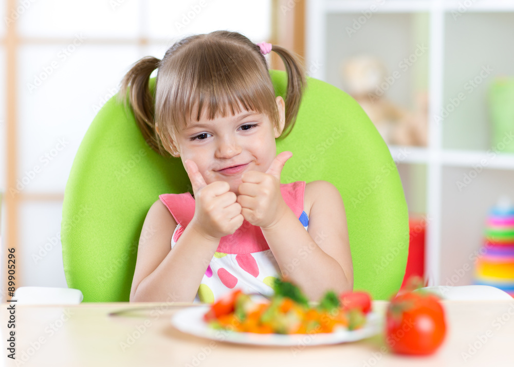 Little girl with vegetables food showing thumb up Little girl with vegetables food showing thumb up