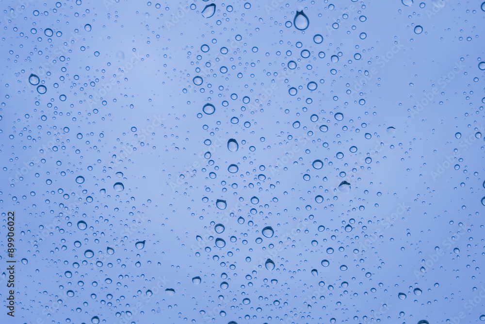 Close-up of water drops on glass surface as background.