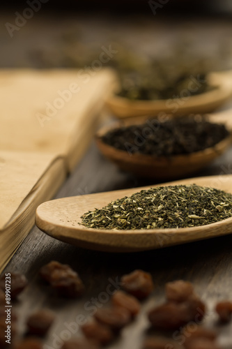 tea collection, flowers, old blank open book on wooden background. Menu, recipe, mock up