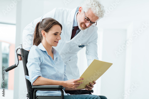 Doctor and patient examining medical records photo