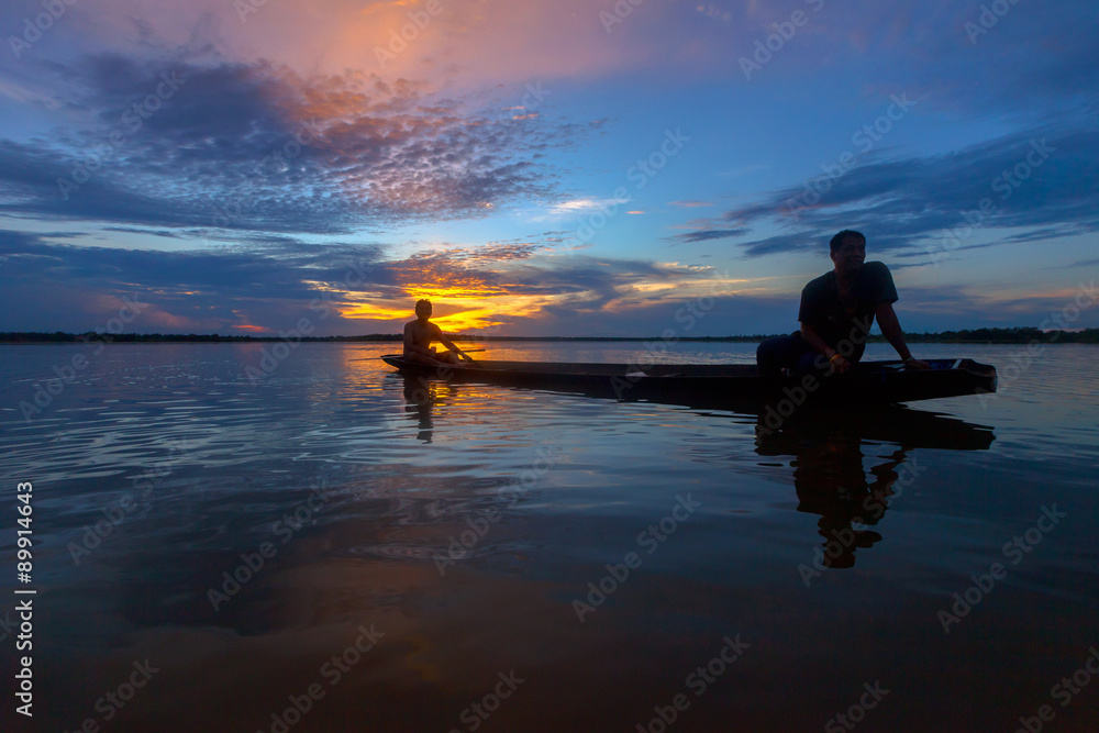 Silhouette fisherman with net at the lake in Thailand