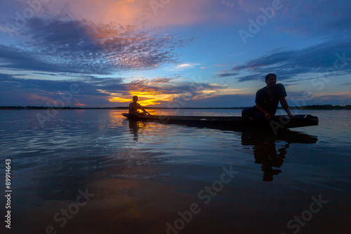 Silhouette fisherman with net at the lake in Thailand