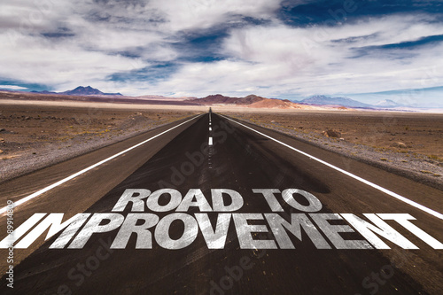 Road to Improvement written on desert road photo