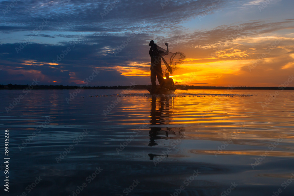 Silhouette throwing fishing net during sunrset, Thailand