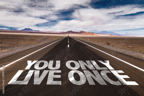 You Only Live Once written on desert road photo