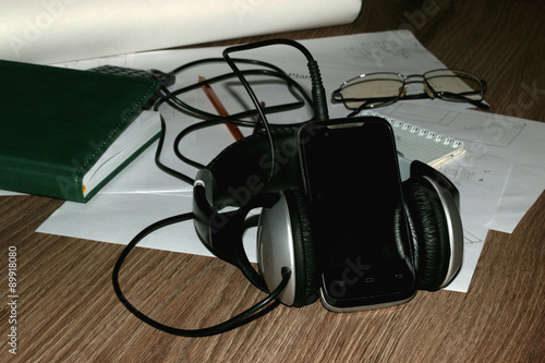 documents headphones and the phone on the table