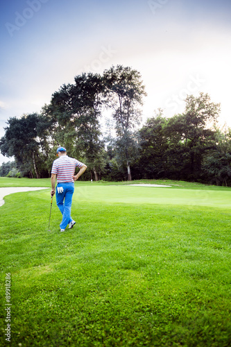 Beautiful golfing scenery with a golfer holding a club