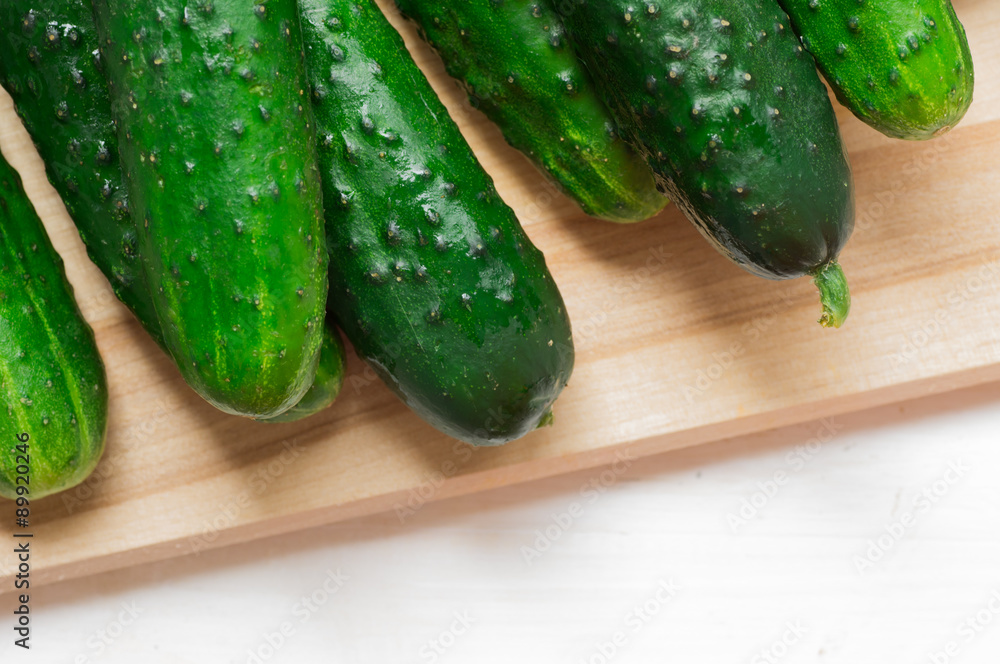 Fresh cucumbers on a chopping board