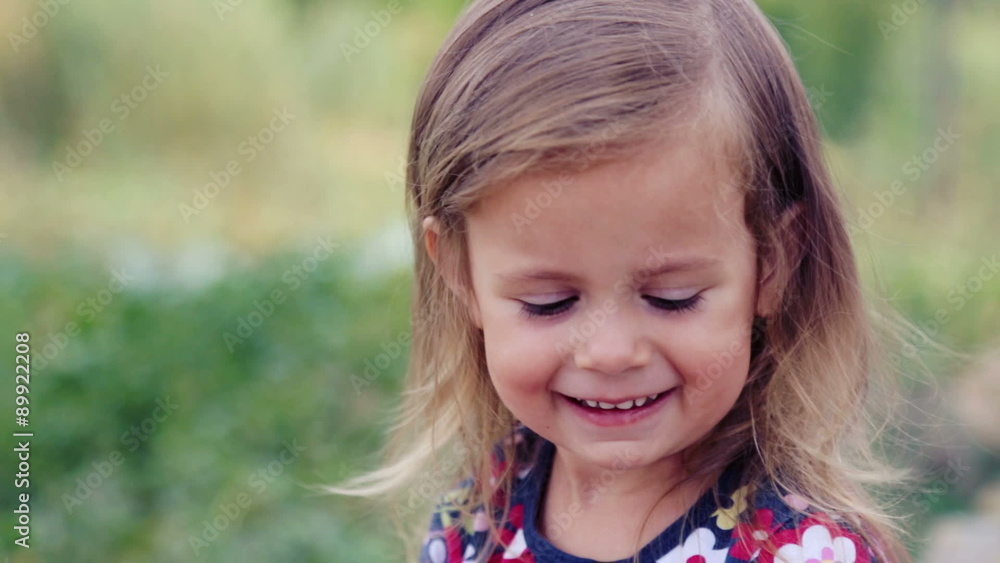 Little girl sitting at home near the grill. Caucasian little girl at a fire near the house. Little girl sitting at home near the grill. Caucasian little girl at a fire near the house.