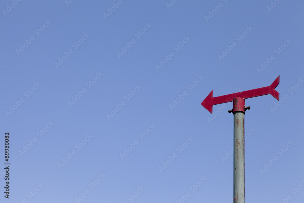 Red empty signpost against clear blue sky, space for text Red empty signpost against clear blue sky, space for text