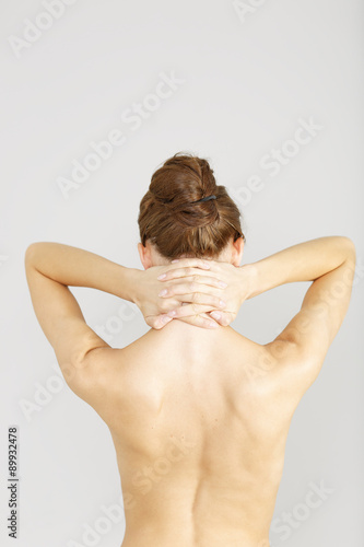 Woman with neck ache massaging