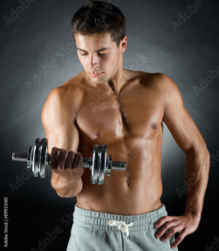 young man with dumbbell