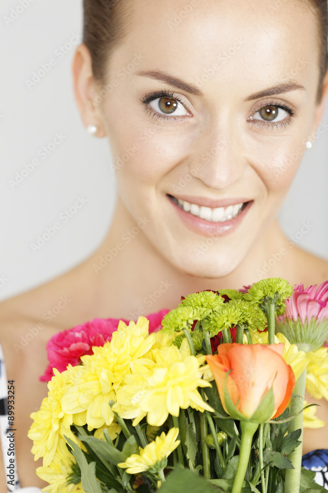 Woman holding a bouquet of flowers Woman holding a bouquet of flowers
