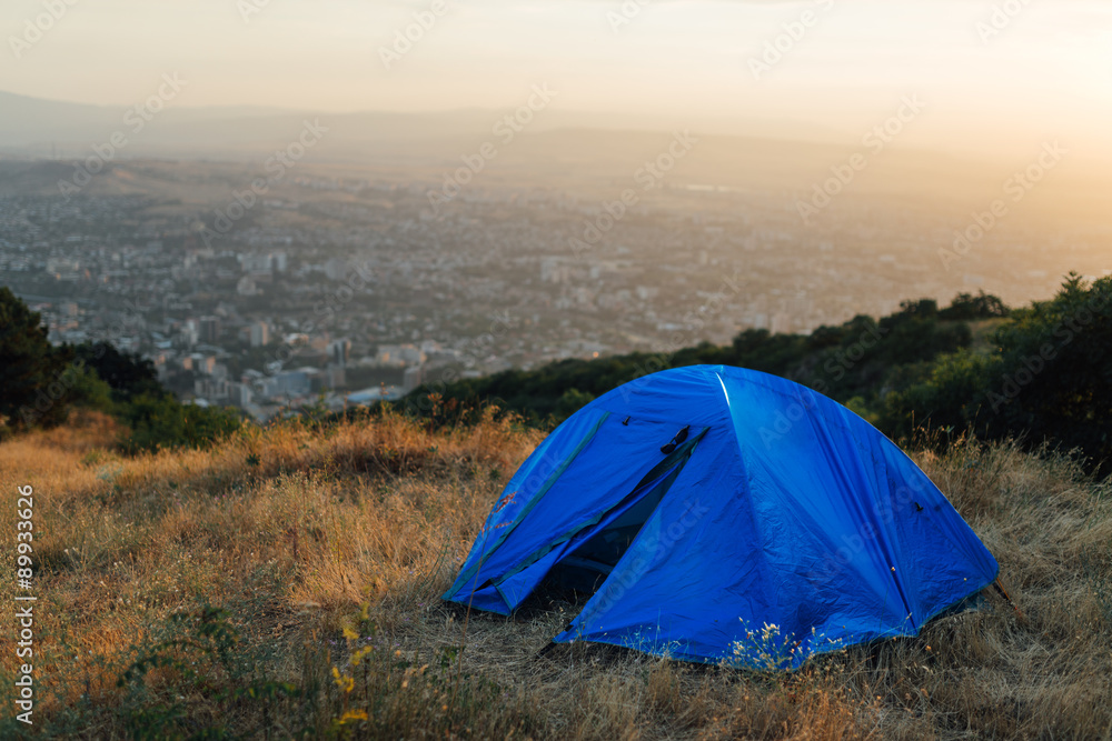 blue tent on a hill near city