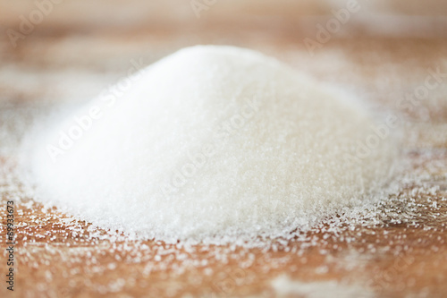 close up of white sugar heap on wooden table