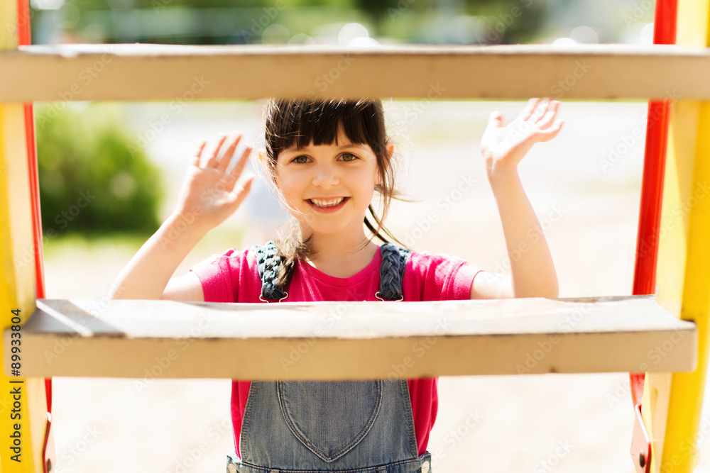 Obraz premium happy little girl climbing on children playground