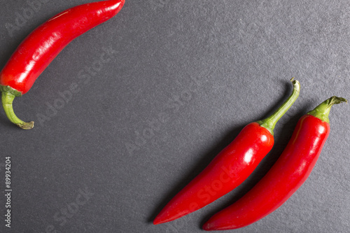 Fresh red chilli on black slate with copy space