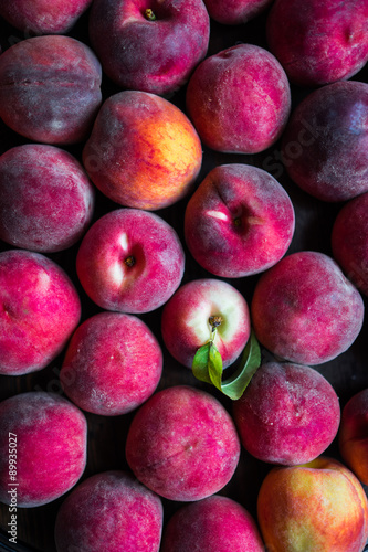 Fresh picked peaches on wooden background