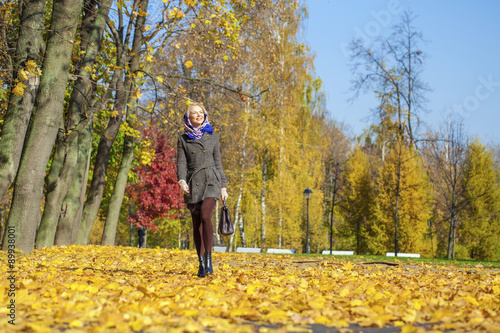 Young woman walking in autumn park