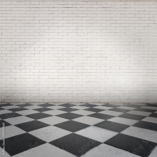 room with white bricks wall and gray floor