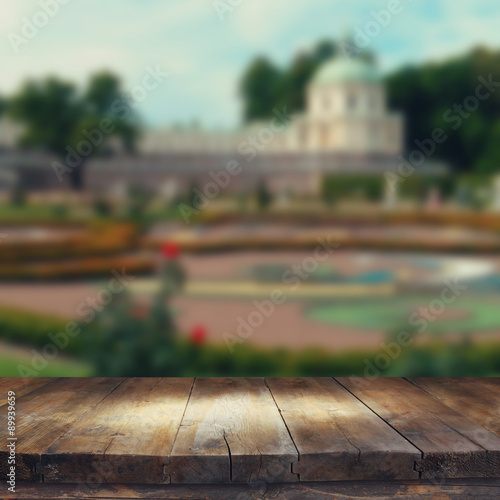 vintage wooden board table in front of rustic counrty garden landscape