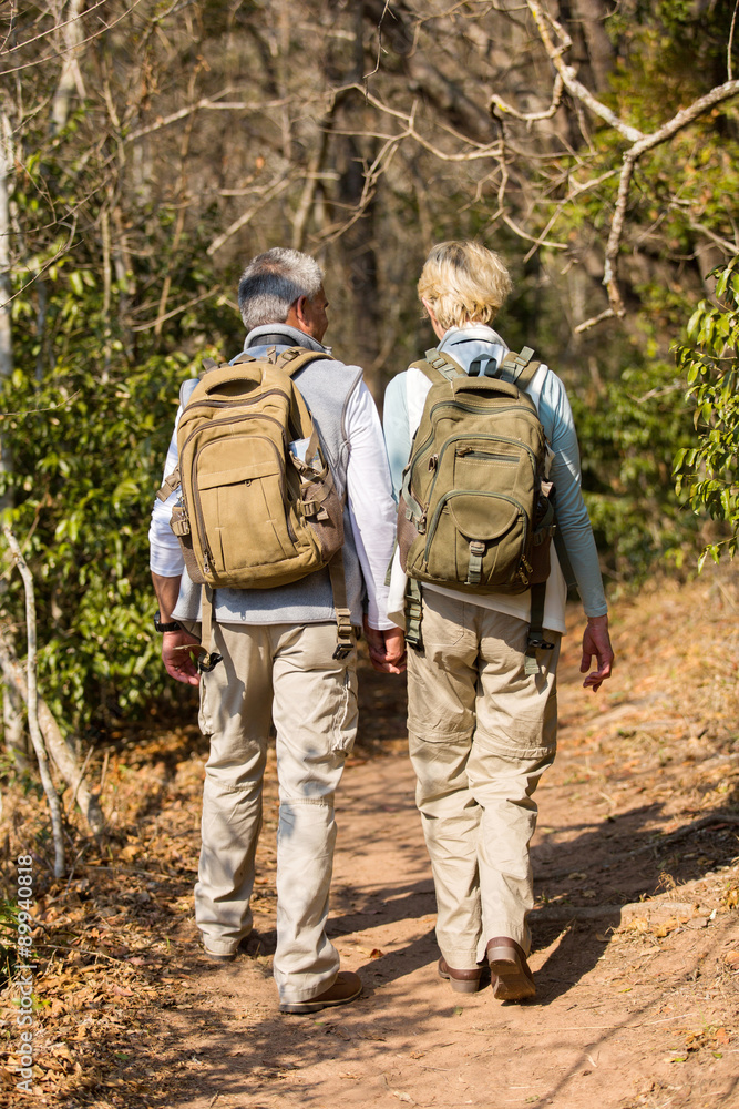 mid age couple hiking in forest