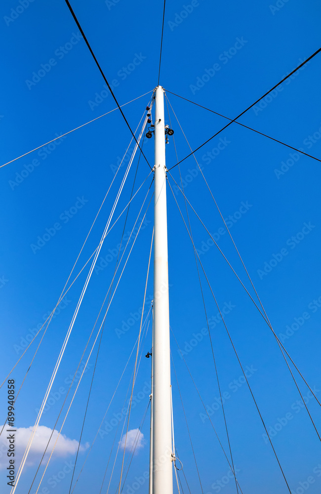 The mast of the ship on a blue sky background The mast of the ship on a blue sky background