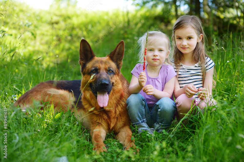 Two happy little girls and their big dog