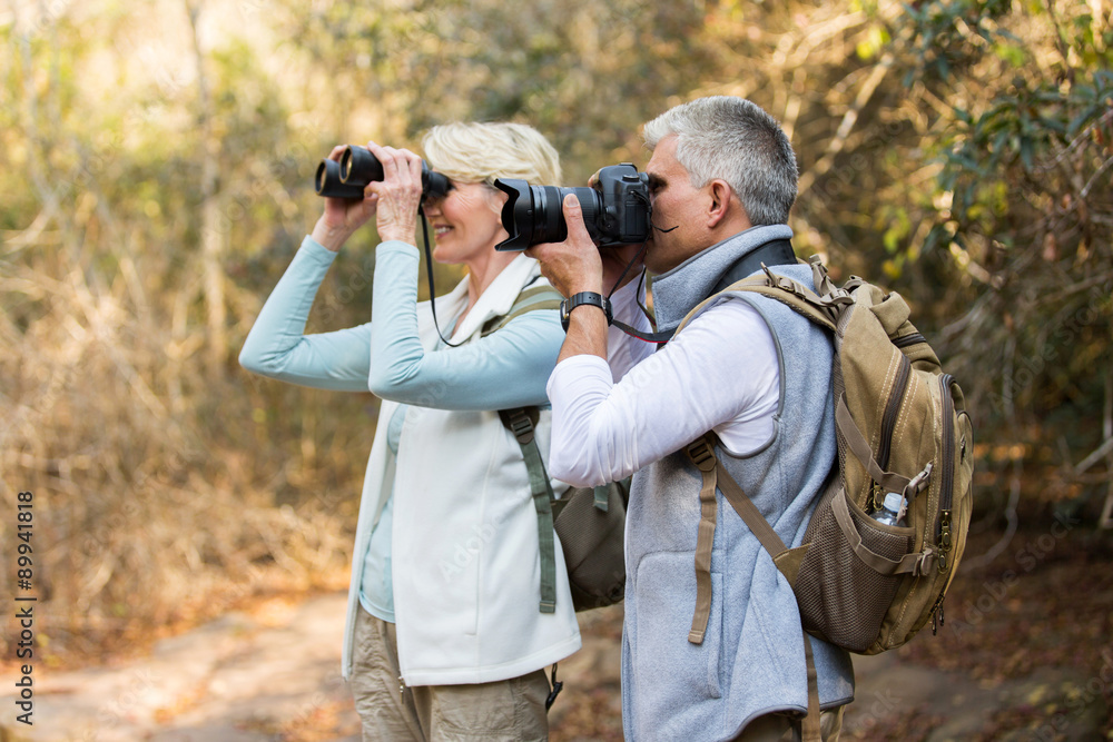 Obraz premium senior hikers at valley of the mountain