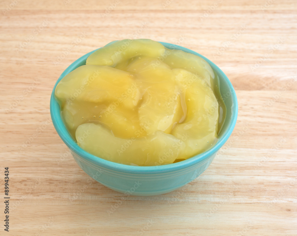 Green bowl filled with canned apple pie filling Green bowl filled with canned apple pie filling