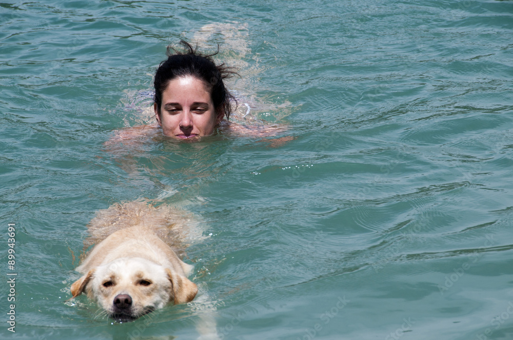 swimming.
girl swimming with your dog